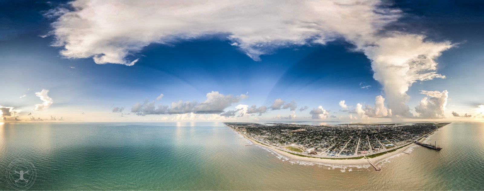 Aerial 360 pano of a coastal city with dramatic cumulus.